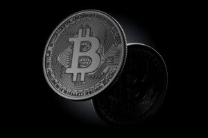 Silver Bitcoin coins on a dark background
