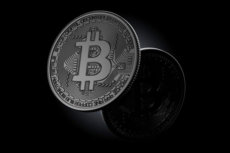 Silver Bitcoin coins on a dark background