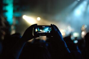Concert crowd filming the stage on a phone