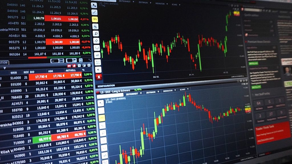 Stock market trading charts on computer screens