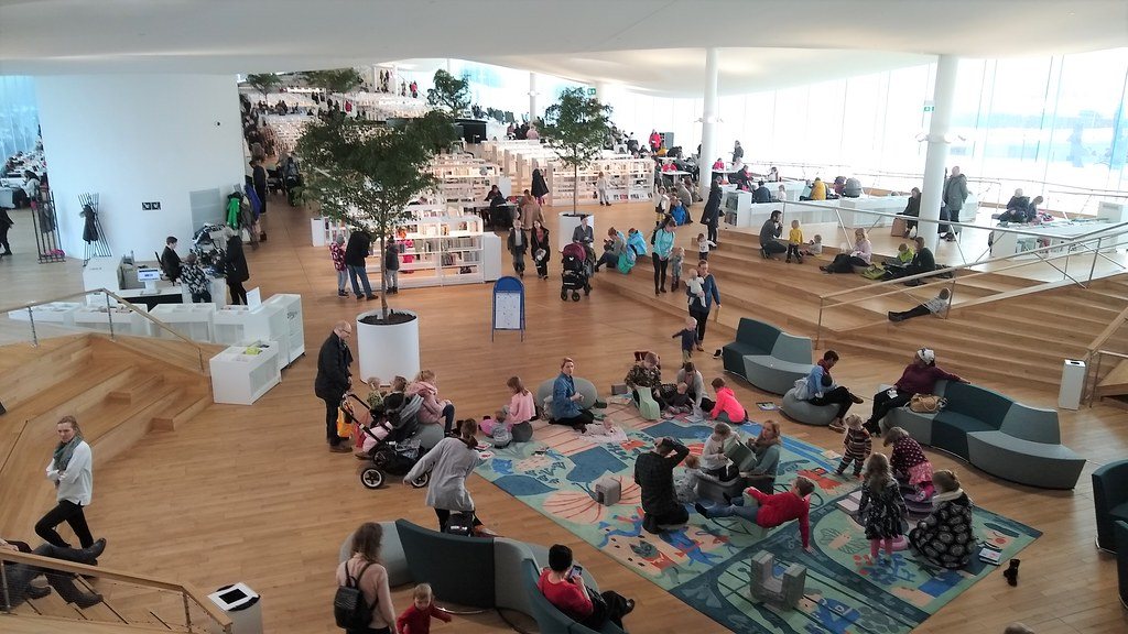People working in a large open-plan office space