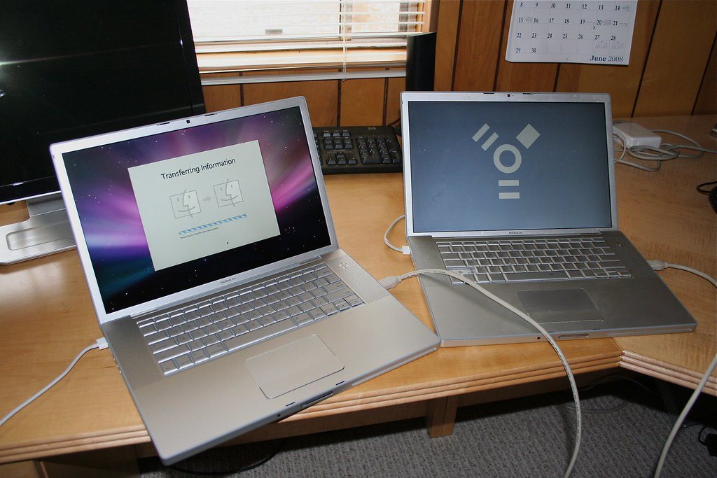 Two laptops open side by side on a desk