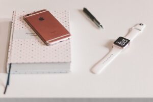 Smartphone and smartwatch on a notebook