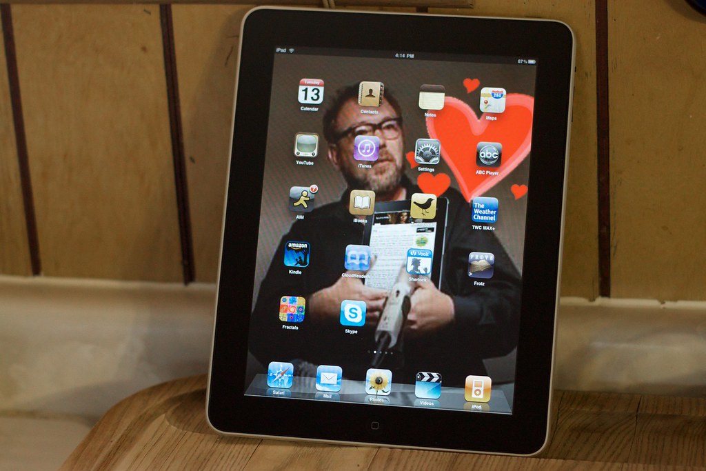 Tablet computer standing on a wooden desk